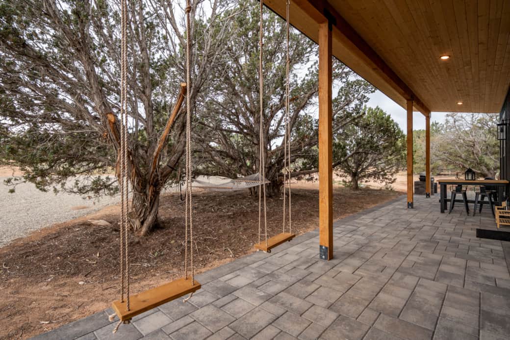 Relax on the porch swing surrounded by nature’s calm.