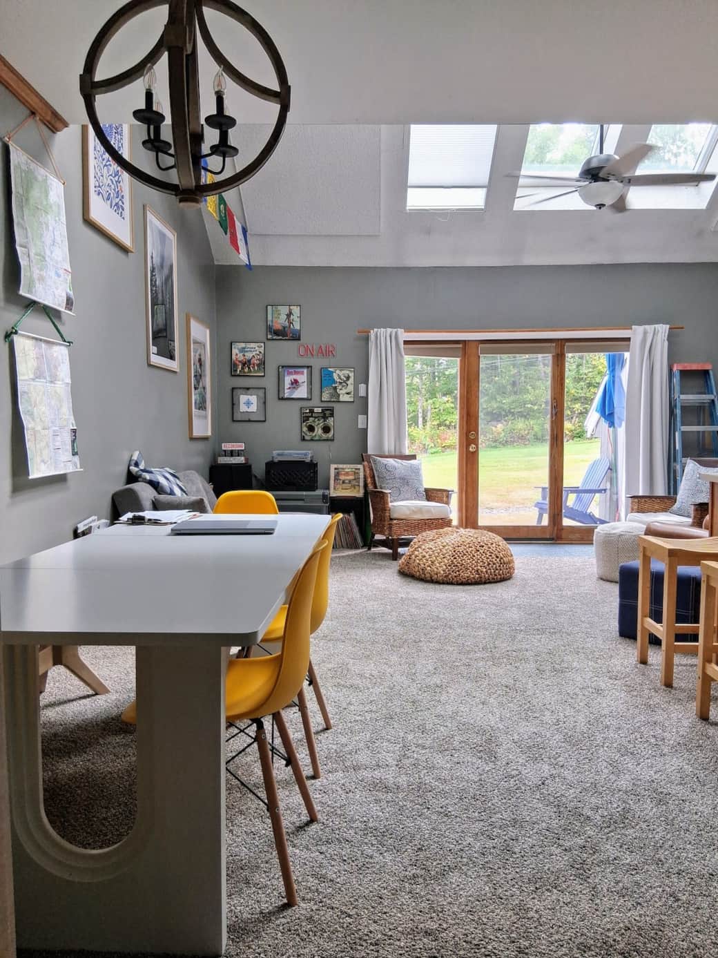 Open concept living room, dining room and kitchen.  Bright and airy space with unique decor, 6 skylights, and doors leading to private back deck and nature.