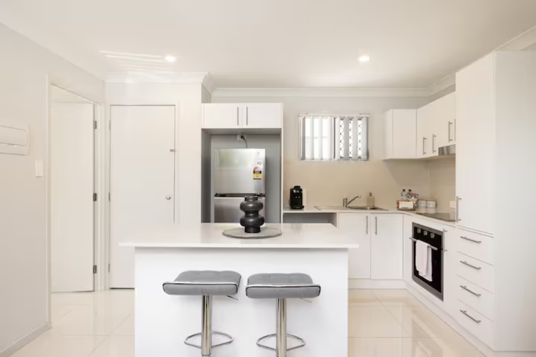 Kitchen: Sleek kitchen with ample storage, modern appliances 