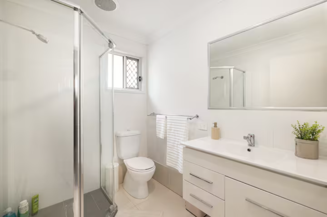 Bathroom: Stylish bathroom with walk-in shower, vanity, and clean finishes 