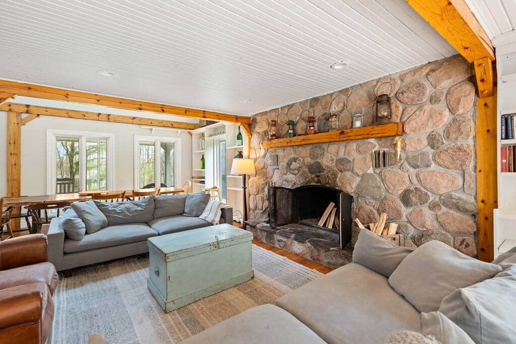 Comfortable and spacious living room with deep couches and massive fireplace.