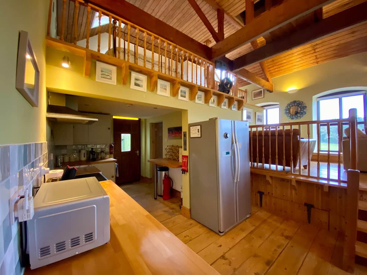 The main living area is open plan, with the dining area, kitchen and access to the single bedroom on the lower level