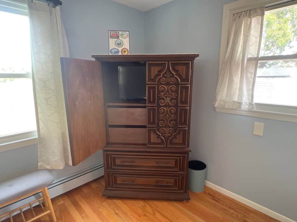 4 drawers of storage, with enclosed TV in bedroom. 