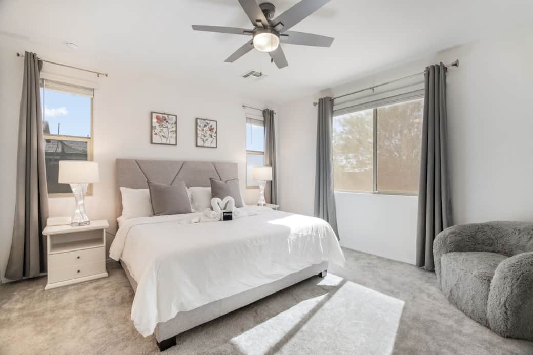 Relax in the luxurious master bedroom with plush bedding"