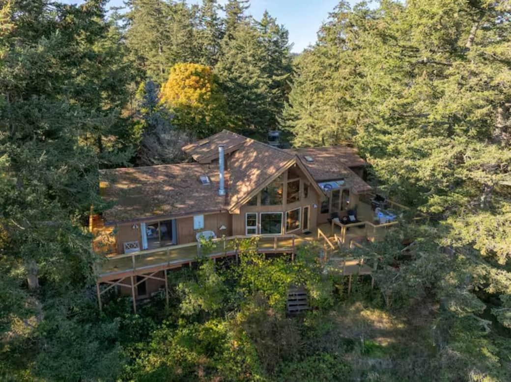 A spacious treetop retreat overlooking Rosario Strait — expansive wraparound decks, floor-to-ceiling windows, and endless forest + water views from nearly every room. A spacious treetop retreat overlooking Rosario Strait — expansive wraparound decks, floor-to-ceiling windows, and endless forest + water views from nearly every room.