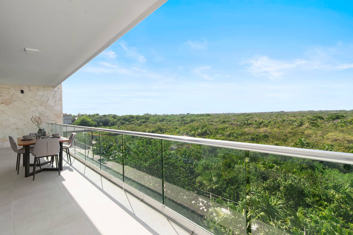 Step onto your private balcony and take in one-of-a-kind Akumal jungle views. Accessible from both the living room and the primary bedroom, it also features an outdoor dining area—the perfect spot for morning coffee, meals, or evening drinks.