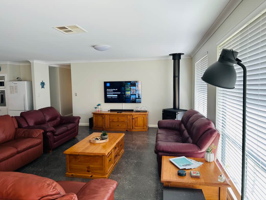 Large living room with 60 inch TV and fireplace