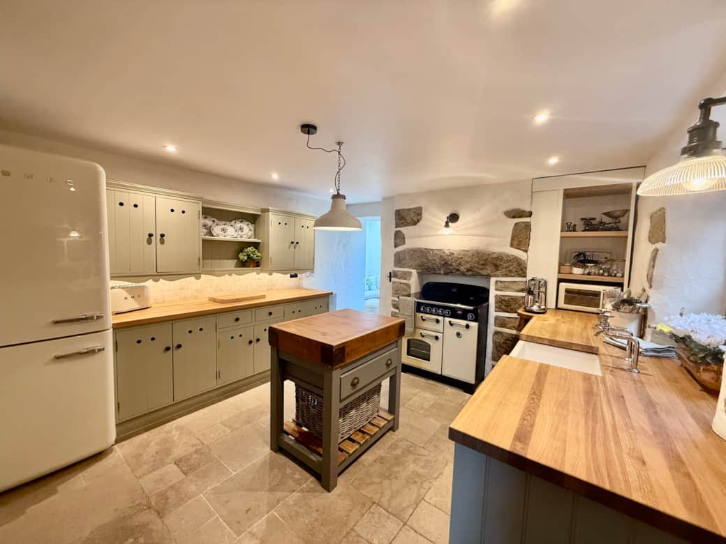 Traditional kitchen with butchers block and modern appliances in Arwel Cottage