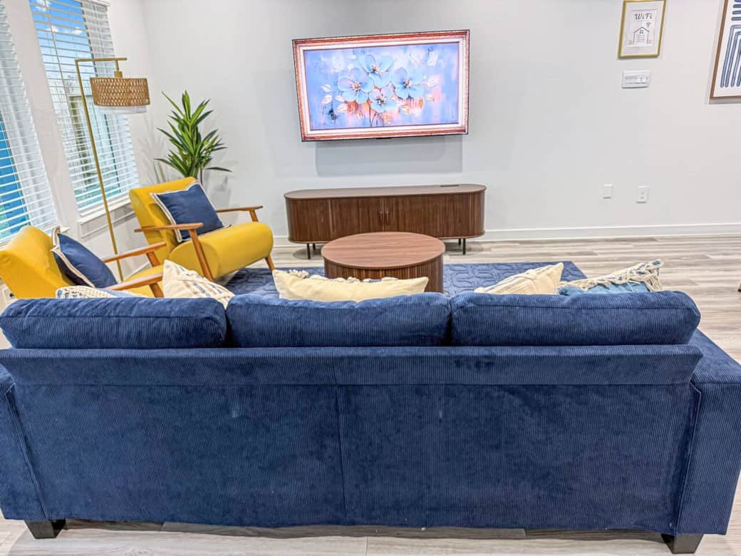 65 in TV neatly hung on the wall with complimentary local channels via digital antenna. Relax on the couch and chairs and enjoy your favorite streamed movies. Coffee table and TV stand is available for your electronic devices and extra storage.