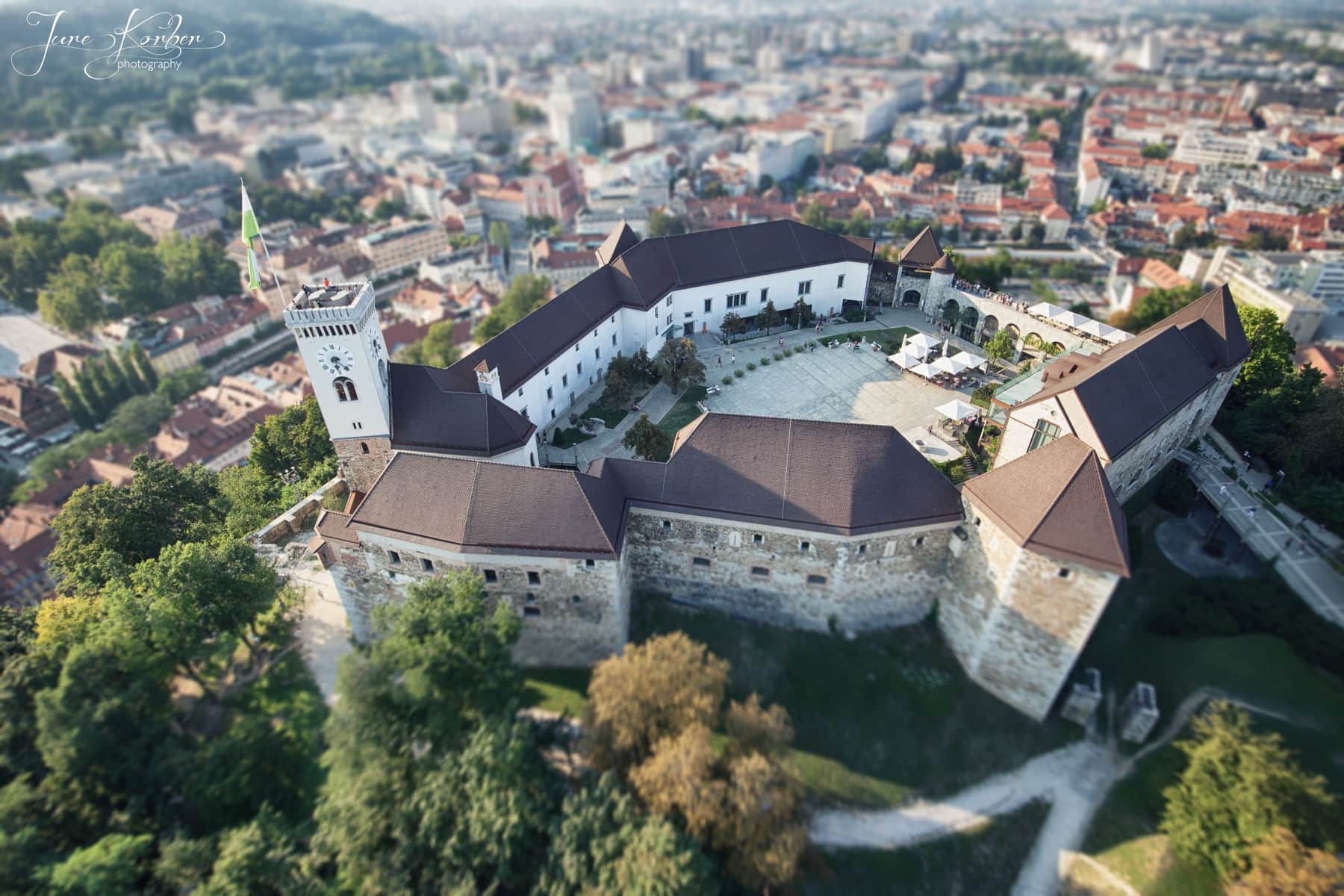 Ljubljana Castle on its forested hill above the old town rooftops