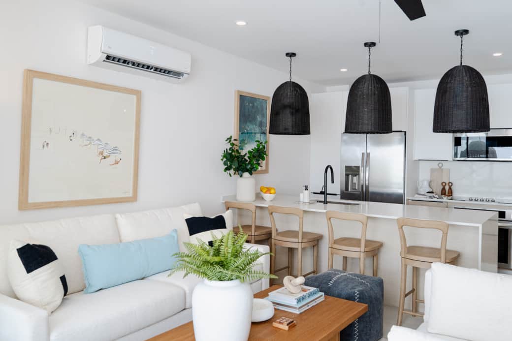 Bright open-plan lounge and kitchen with island seating, cozy sofas, and seamless indoor-outdoor flo Bright open-plan lounge and kitchen with island seating, cozy sofas, and seamless indoor-outdoor flo