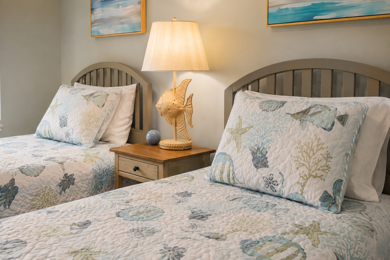Two beds share a nightstand, keeping the lamp within easy reach for both sleepers.