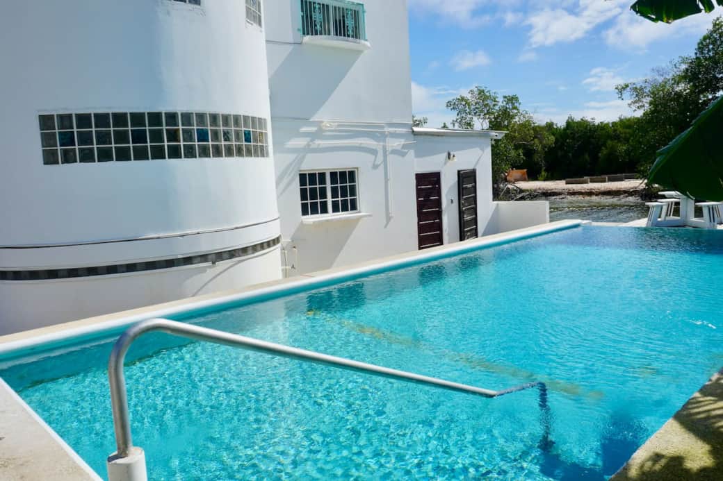large pool with crystal clear water and overwater deck