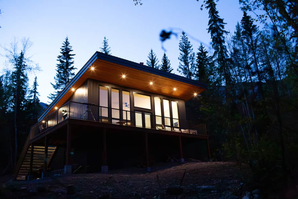 Night view of the cabin with lights around the cabin.