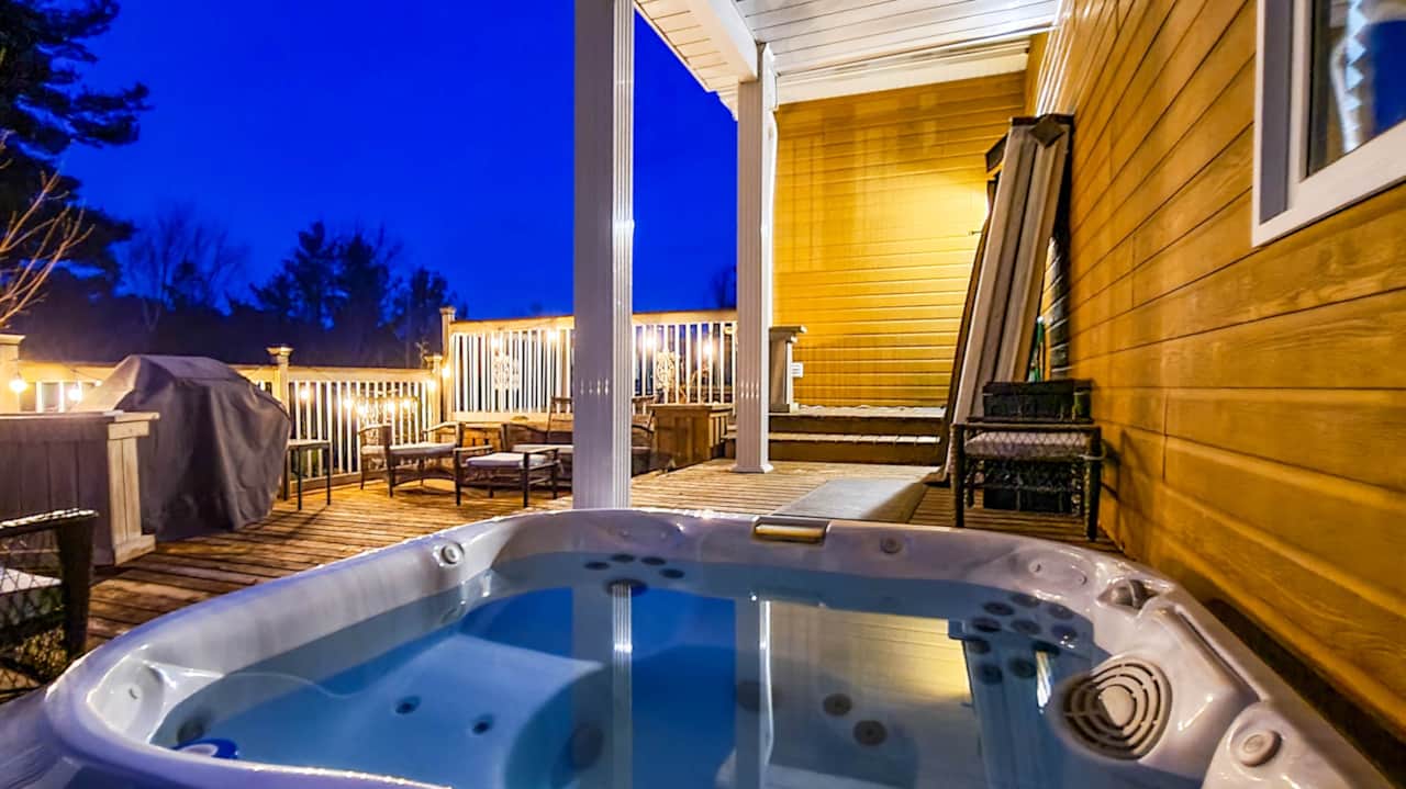 Hot tub with deck seating and stunning views of the lake 