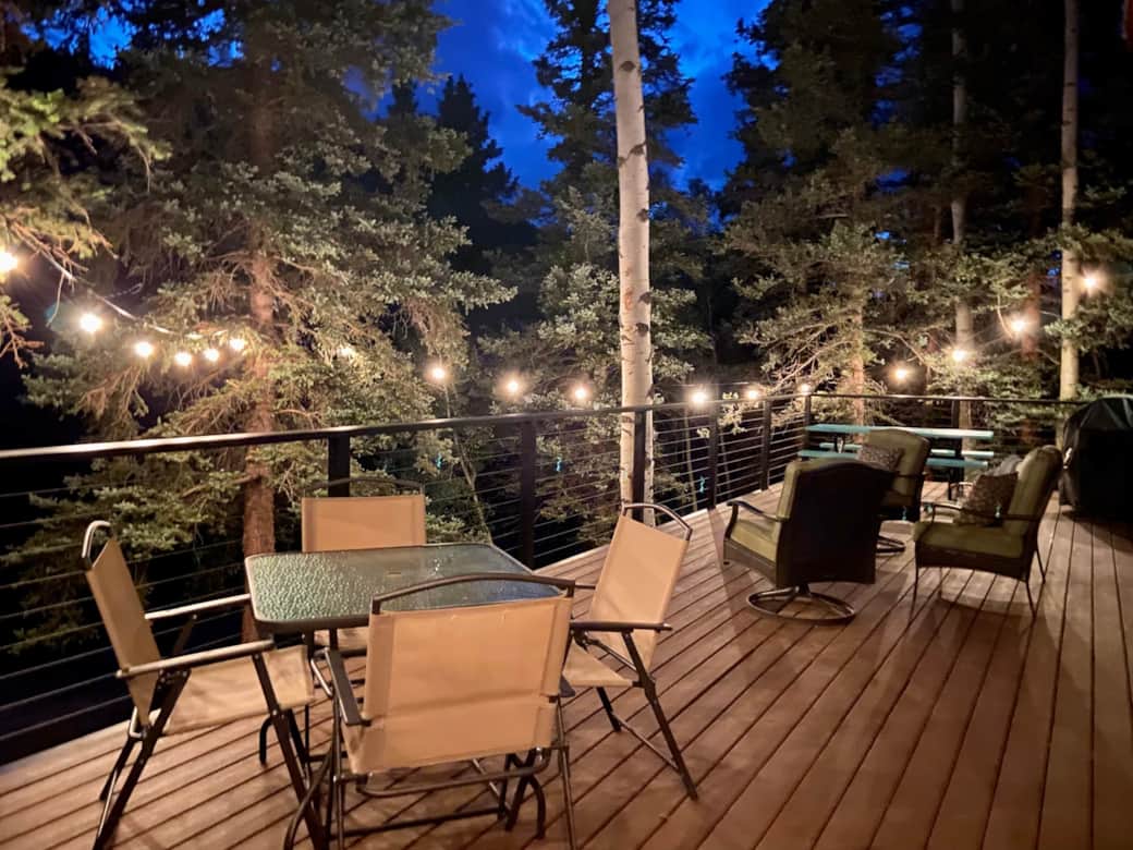 Cafe lights hang from the trees to extend your evenings Cafe lights hang from the trees to extend your evenings