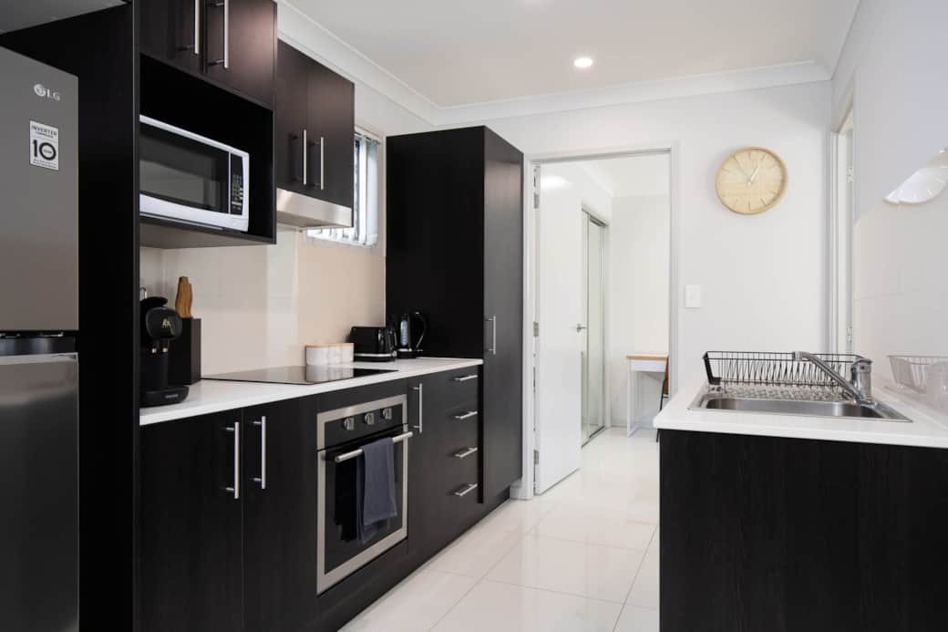 Kitchen: Sleek kitchen with ample storage, modern appliances 