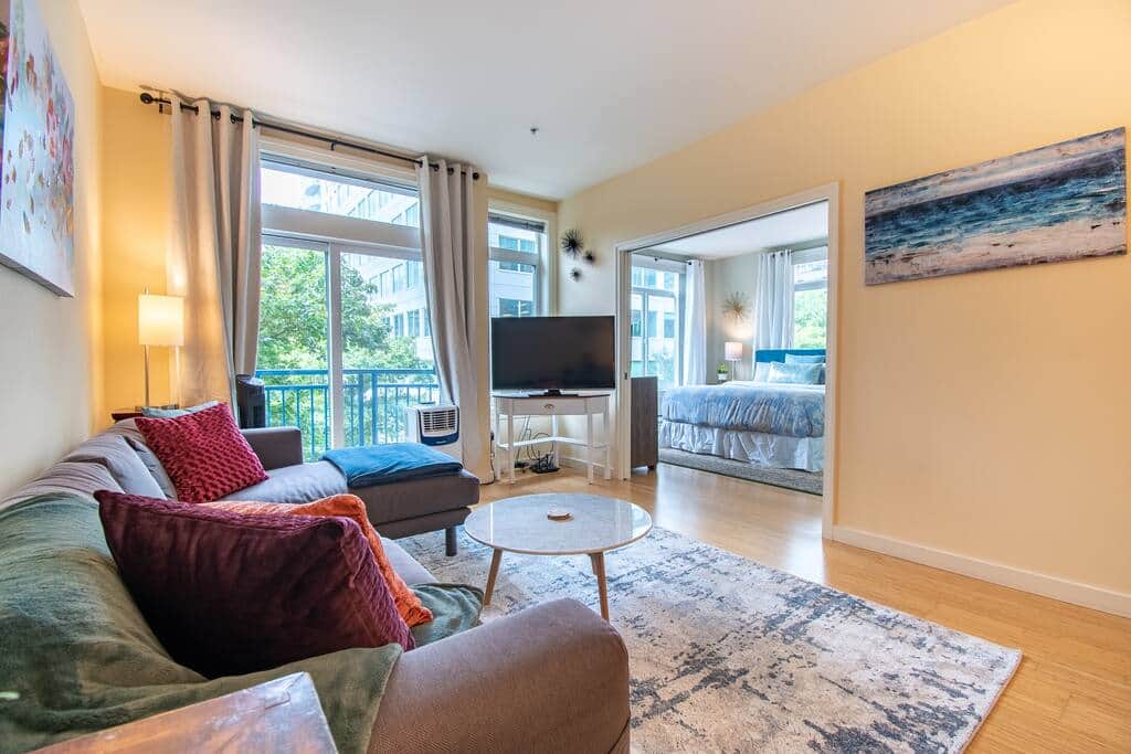 Spacious living room with beautiful bamboo floors large screen TV