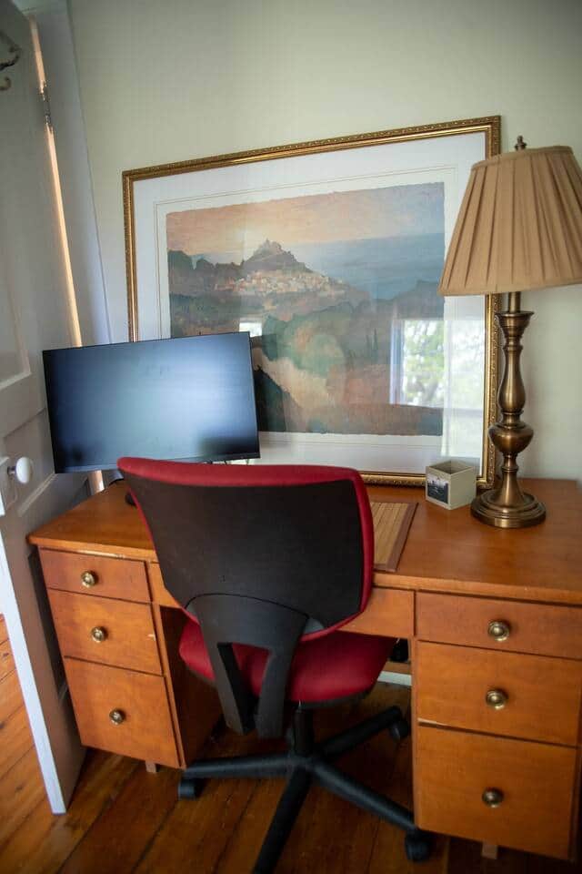 Desk workspace with computer monitor.