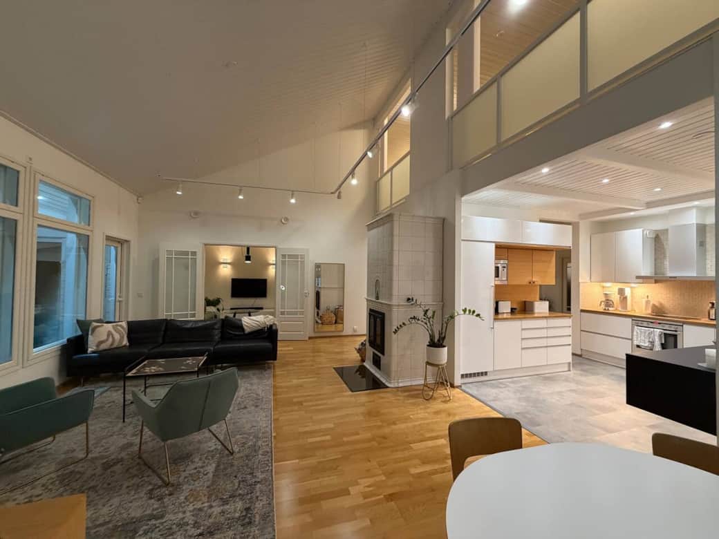 Lounge and kitchen with TV room in the background.