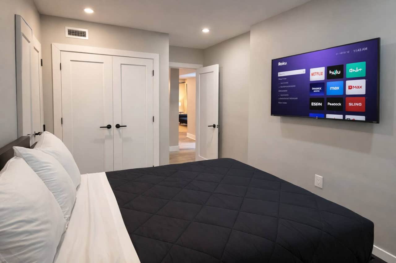 Modern, cozy bedroom with a queen bed, Roku TV, and spacious closet—clean, comfortable, and perfect for relaxing.