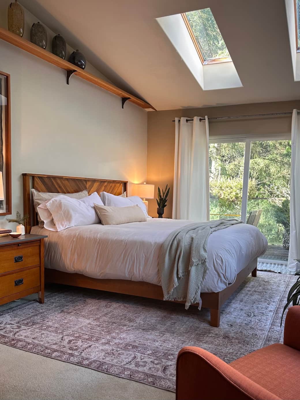 The bedroom features a king-size bed with cotton sheets and a down duvet, plus a wall-mounted TV for relaxed evenings in.