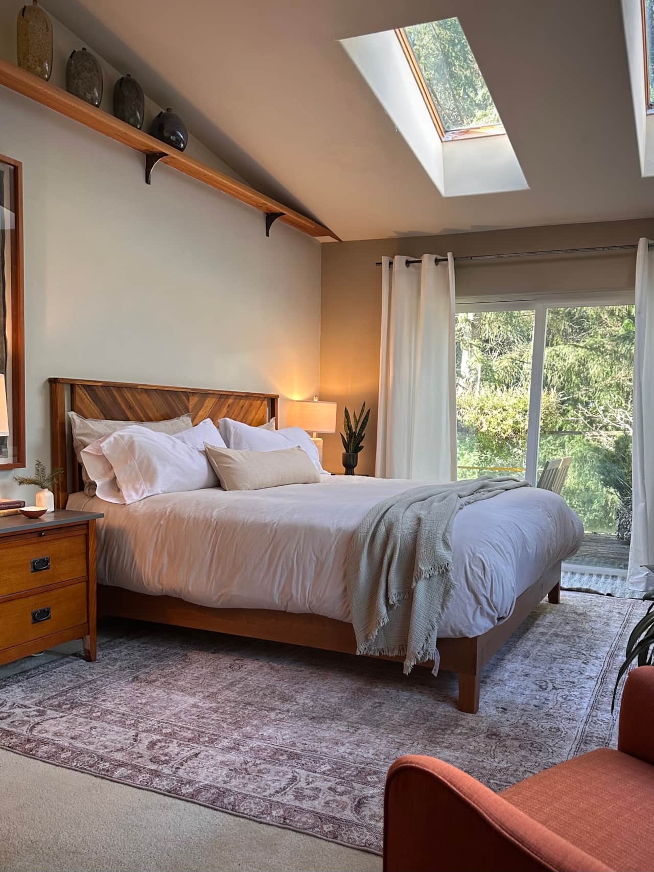 A king-size bedroom surrounded by trees.