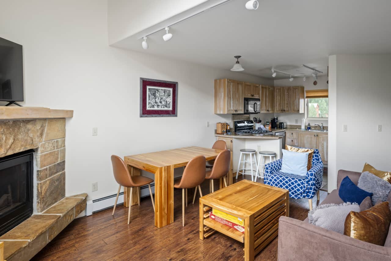 Comfortable family seating area with adjacent dining table and fully stocked kitchen