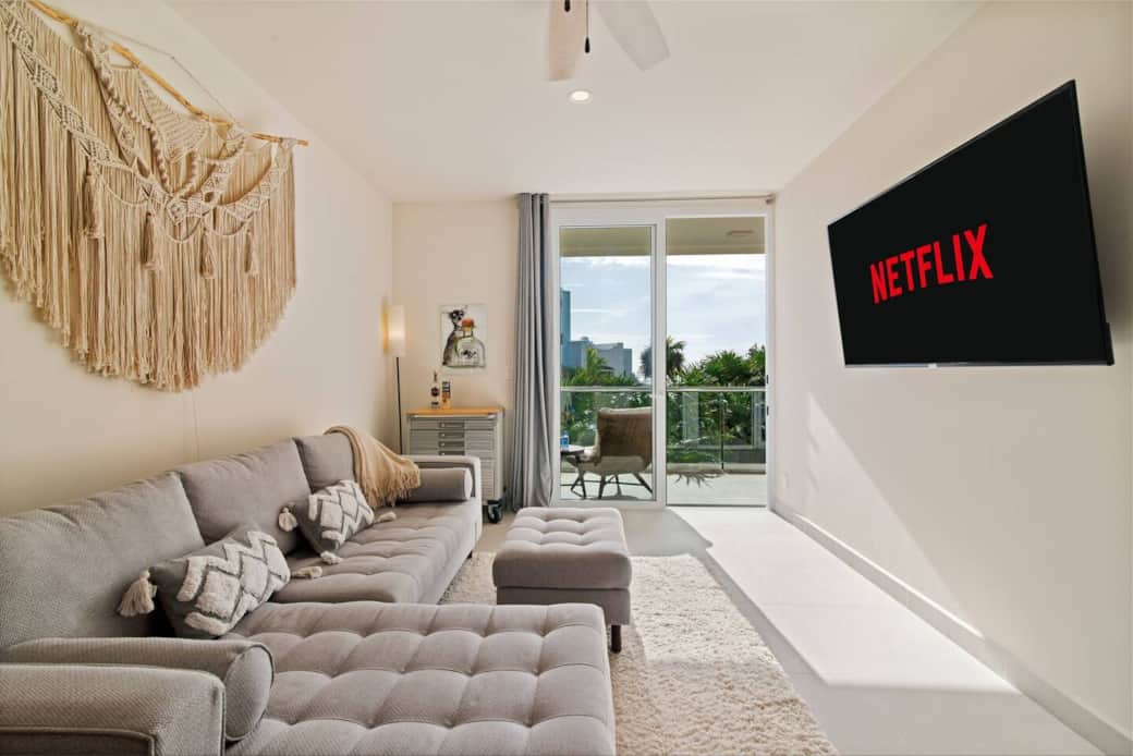 Not only does this living room have a private balcony, but it also features a 65-inch Smart TV so you can enjoy your favorite movies and shows.
