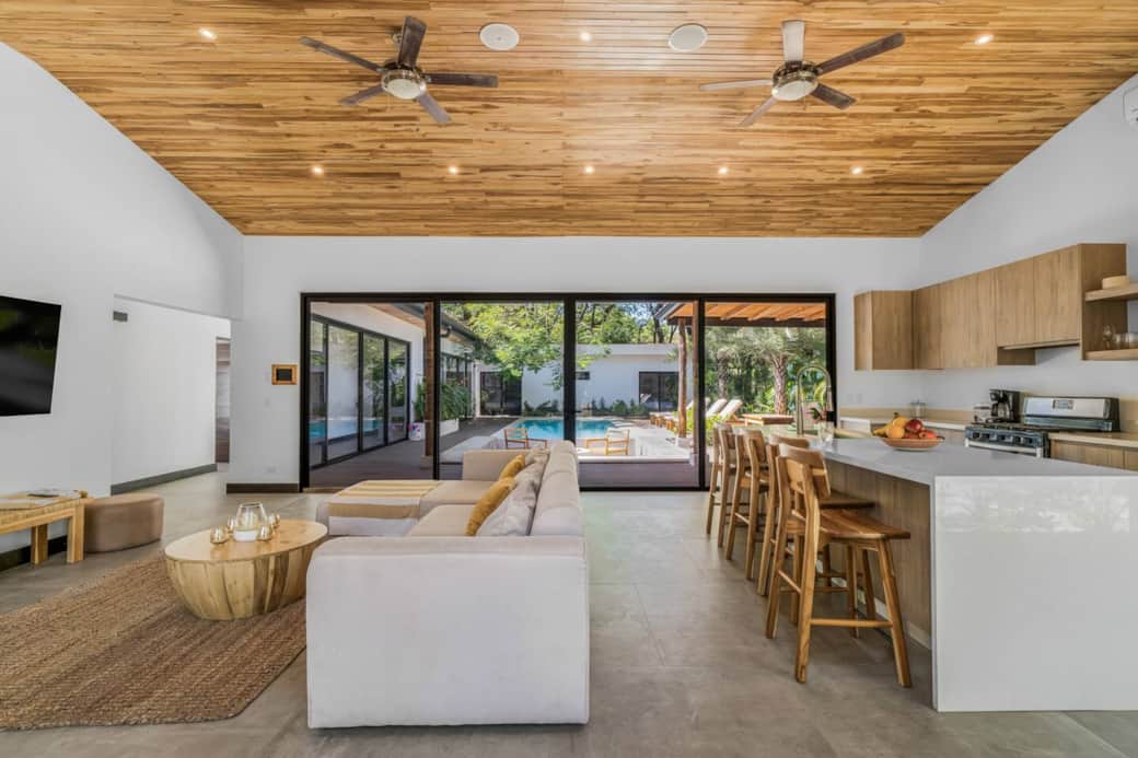 Open-space kitchen and living room with a view of the pool 