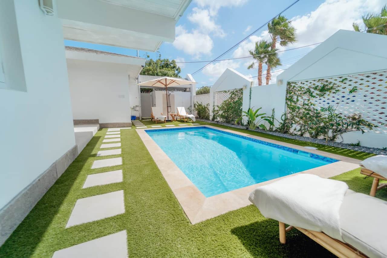 Private pool surrounded by lush greenery and sunshine