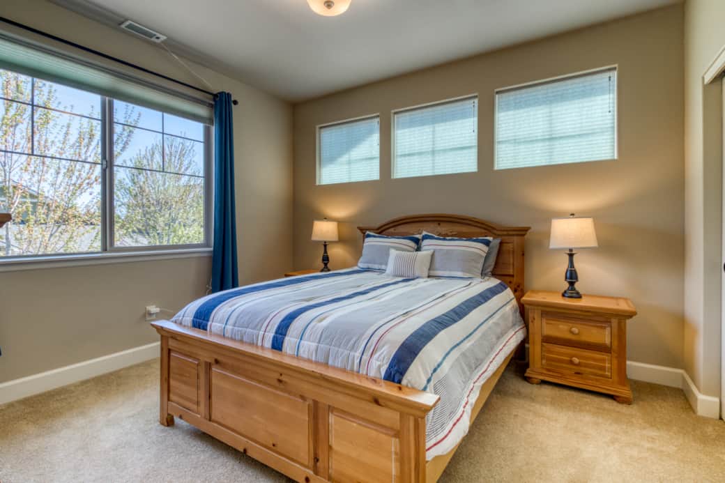Second upstairs queen bedroom with large windows and natural light