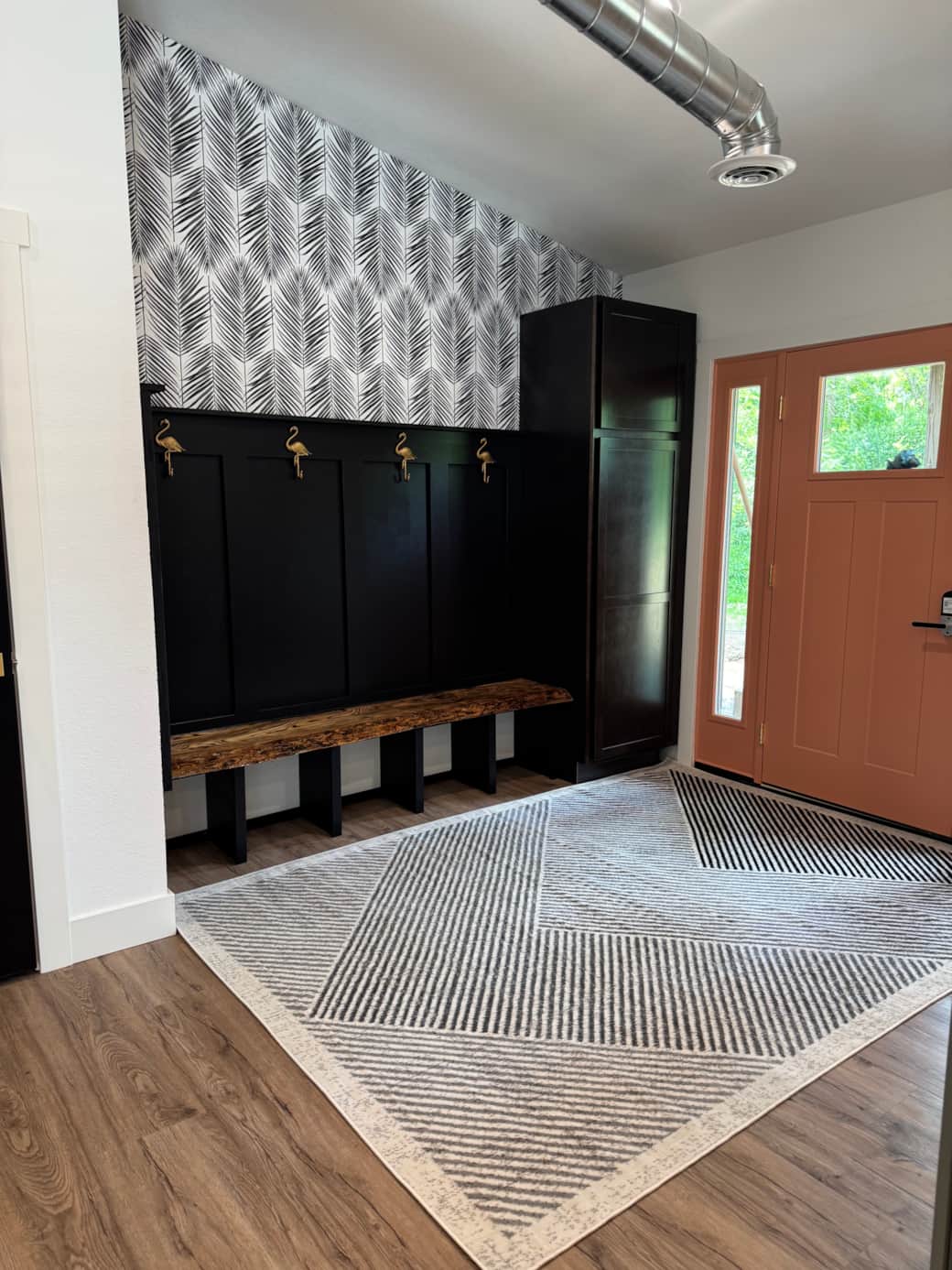 Unique entryway with live edge bench and plenty of storage for coats & shoes.