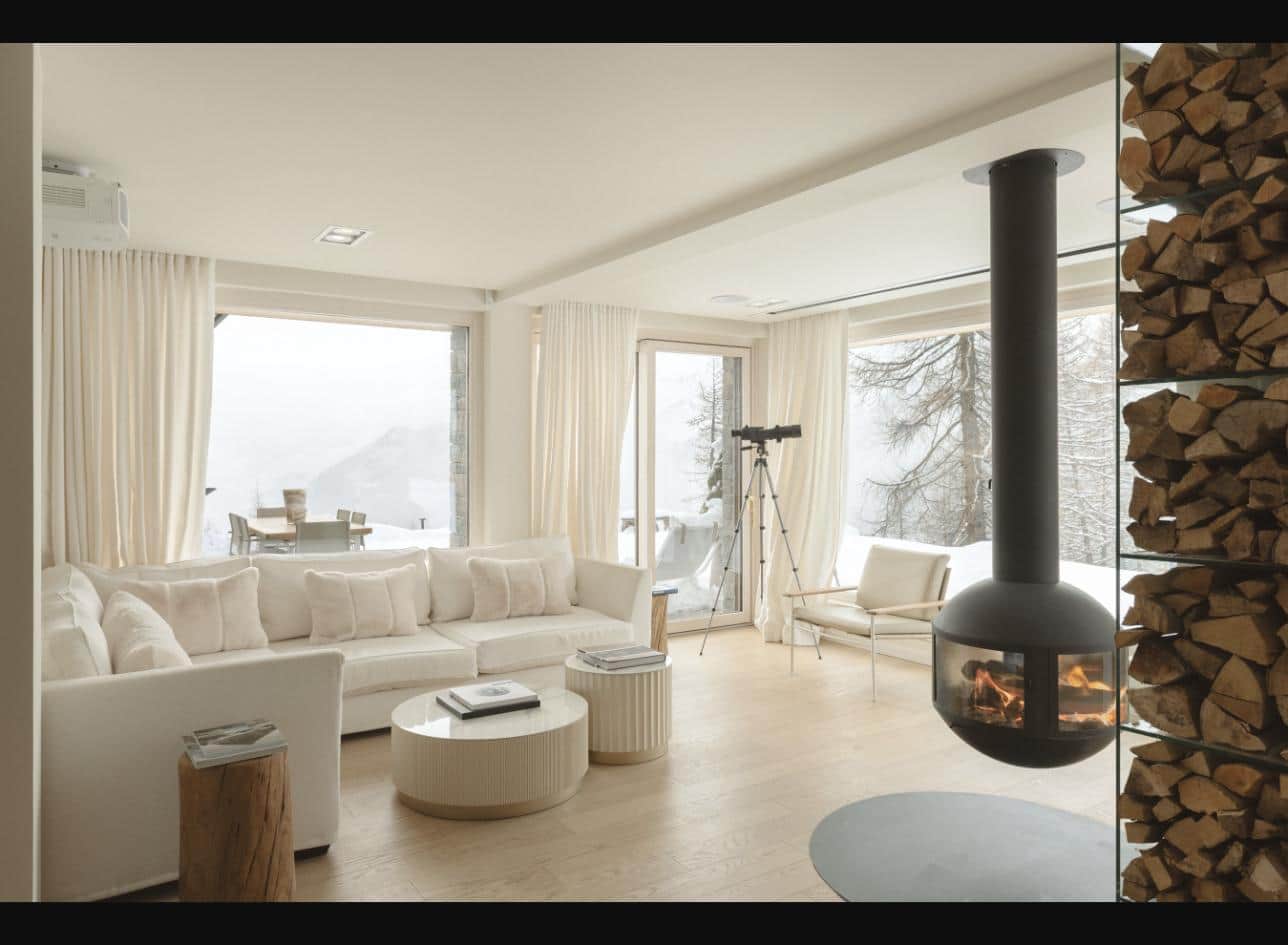 Living room with suspended fireplace, telescope and mountain views