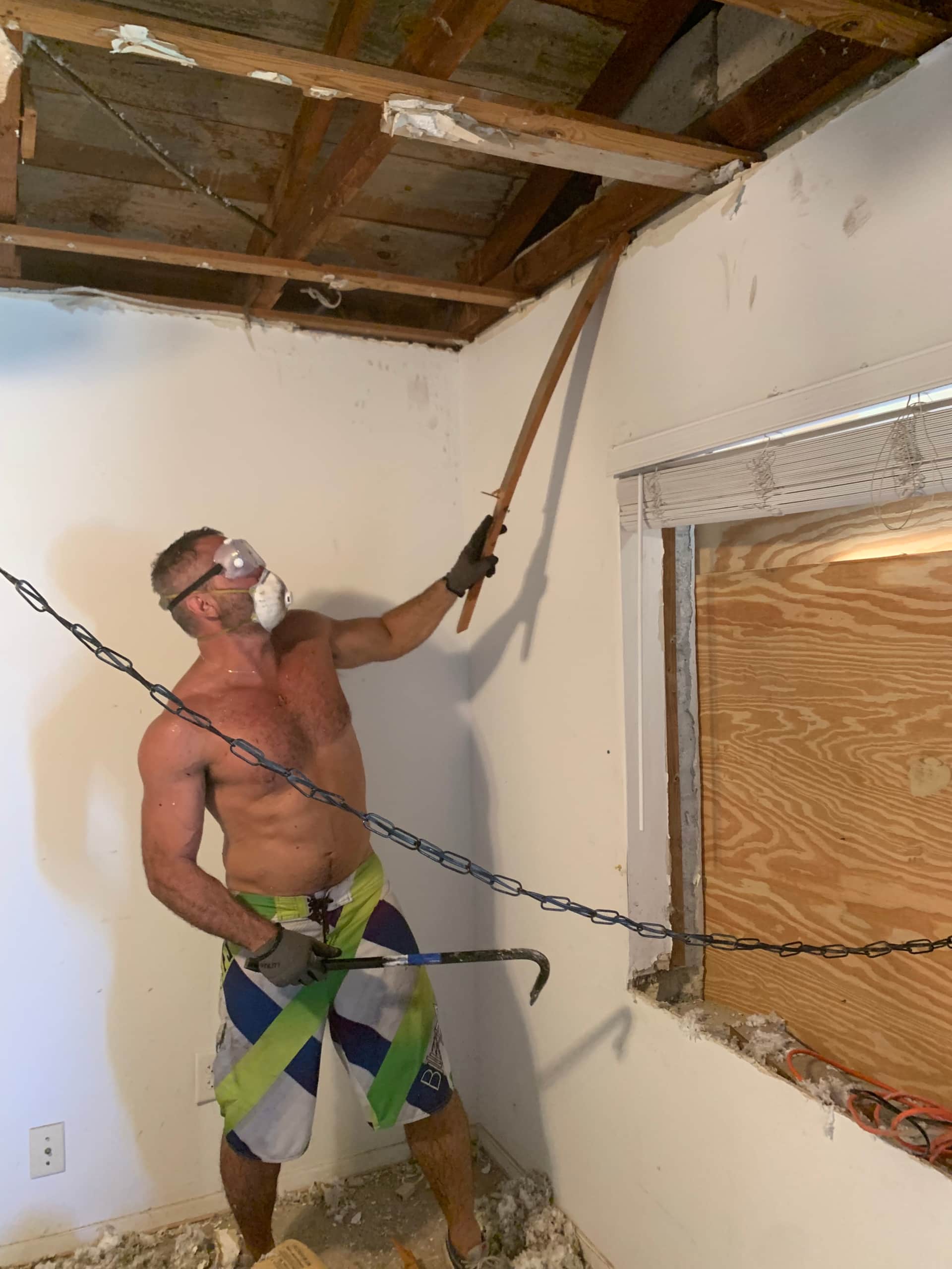 Unit 2 renovation in progress at Casa Citron, exposing original ceiling beams during demolition to transform the space into a bright cottage-style guest suite in Fort Lauderdale