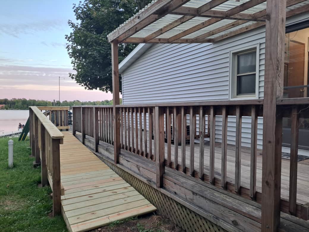 Wraparound deck includes ramp for easy accessibility
