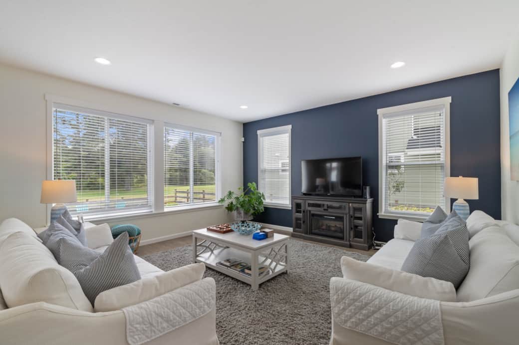 Plenty of seating and natural light make the living room the perfect spot to enjoy time together.