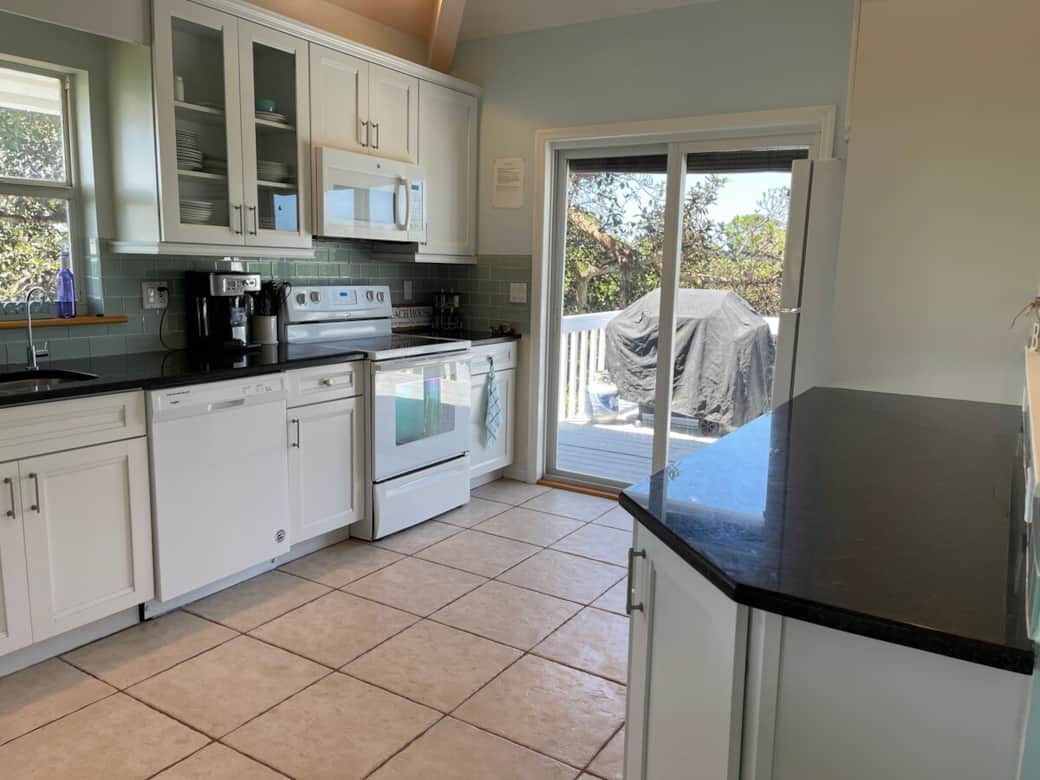 Kitchen with entrance to outside deck for easy indoor-outdoor living.  Fully stocked kitchen for preparing island cuisines.