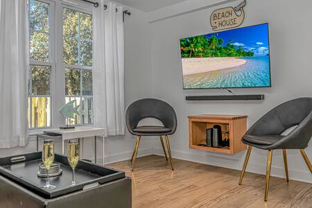 Downstairs living room with accent chairs and Smart Roku TV!