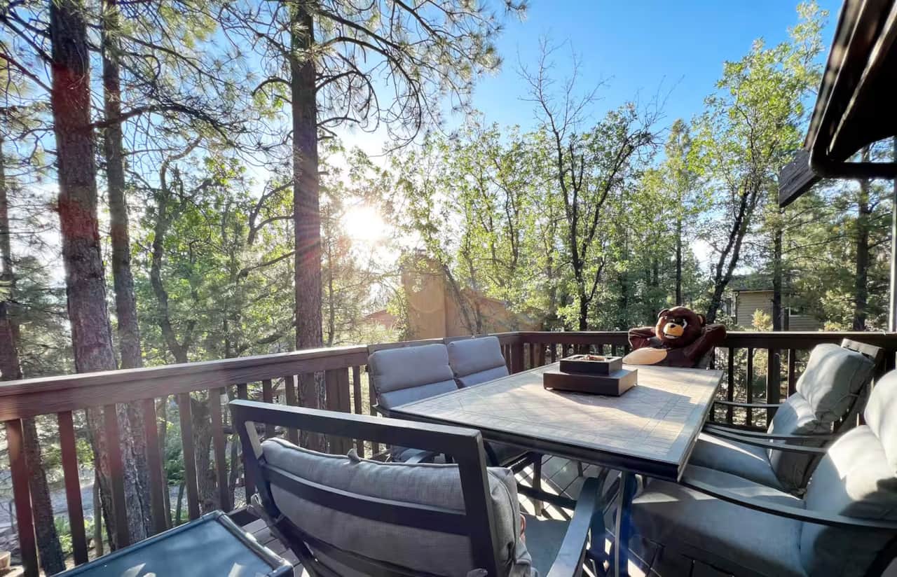 Sunny deck with table and chairs at mountain cabin near Flagstaff