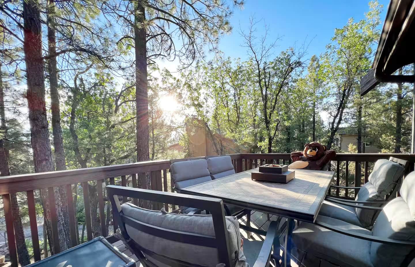 Sunny deck with table and chairs at mountain cabin near Flagstaff