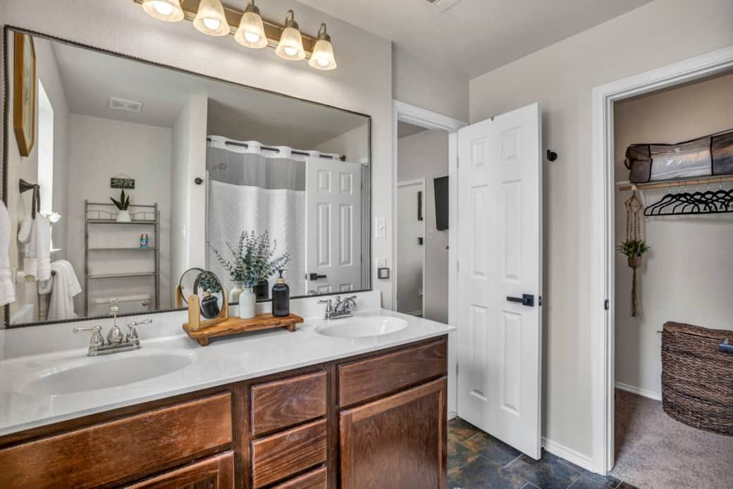 Full bathroom located in the primary bedroom equipped with a large soaking tub, detachable shower head, hand soap, shampoo, conditioner, body wash, blow dryer, towels and wash cloths, makeup remover towels, cleaning supplies, and ample storage space. Full bathroom located in the primary bedroom equipped with a large soaking tub, detachable shower head, hand soap, shampoo, conditioner, body wash, blow dryer, towels and wash cloths, makeup remover towels, cleaning supplies, and ample storage space.