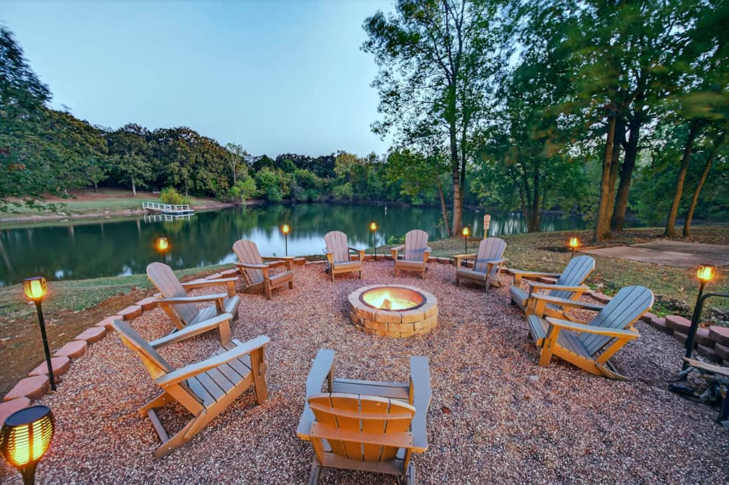 Fire pit overlooking the pond with torch lights and peaceful views