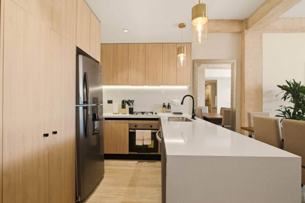 Fully equipped kitchen with everything you need to prepare and enjoy meals, including a refrigerator, microwave, coffee maker, toaster, blender, 4-burner stove, oven, dishwasher, and all essential cookware and silverware for a comfortable stay.