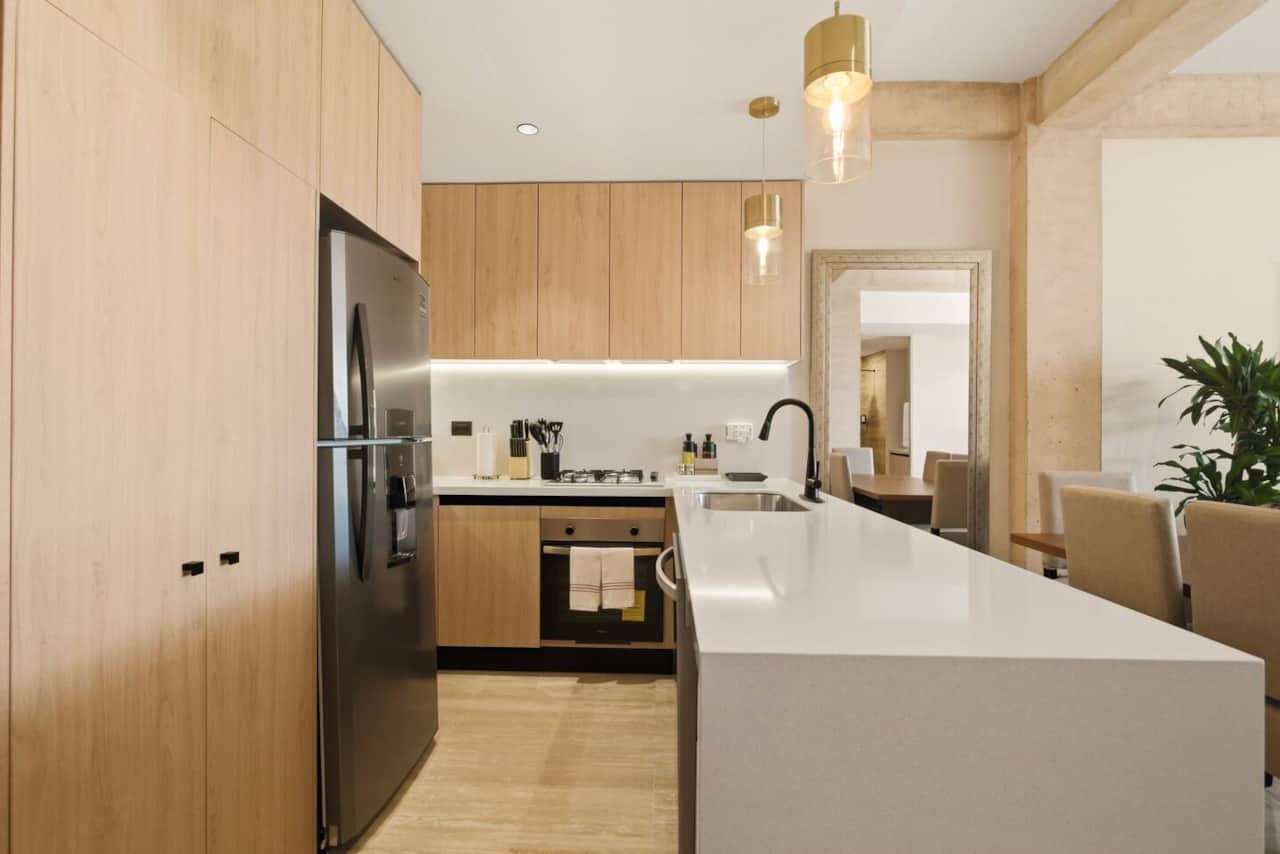 Fully equipped kitchen with everything you need to prepare and enjoy meals, including a refrigerator, microwave, coffee maker, toaster, blender, 4-burner stove, oven, dishwasher, and all essential cookware and silverware for a comfortable stay.