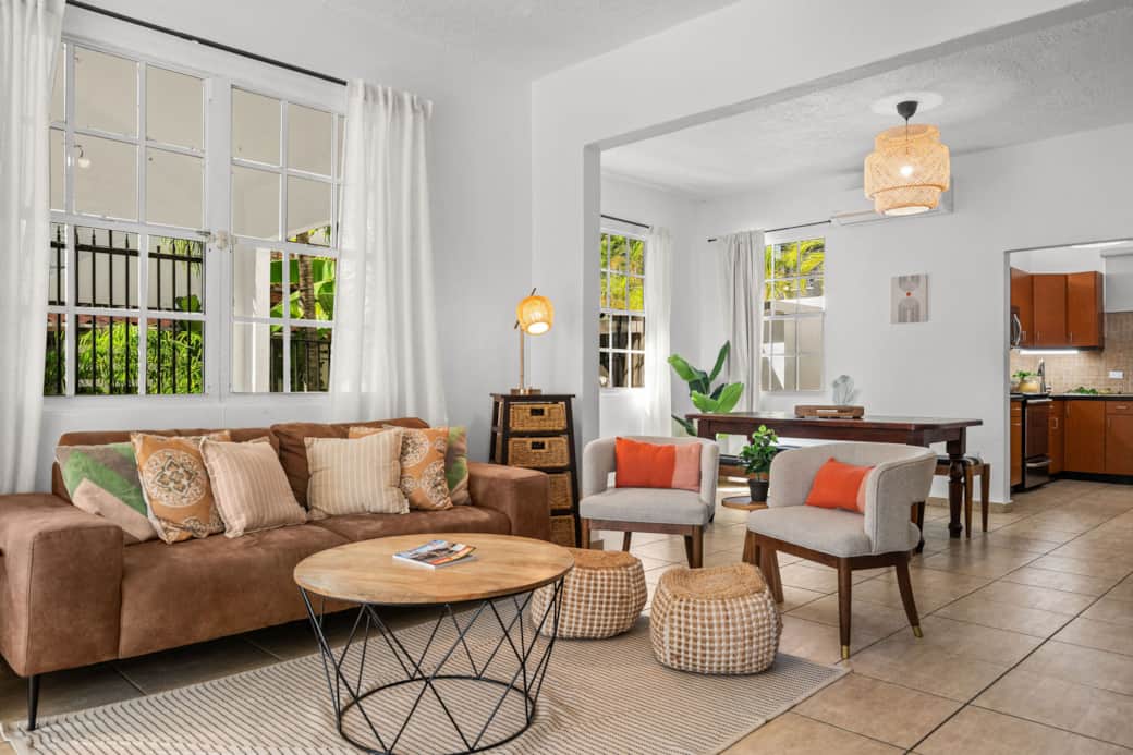 Bright tropical living area with boho decor and natural light