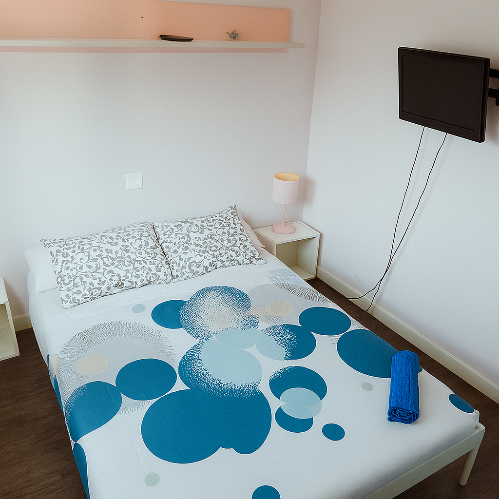 Double bed (1.35 x 1.90 m) with TV, wardrobe, and bedside table. A cozy and functional space for you. 