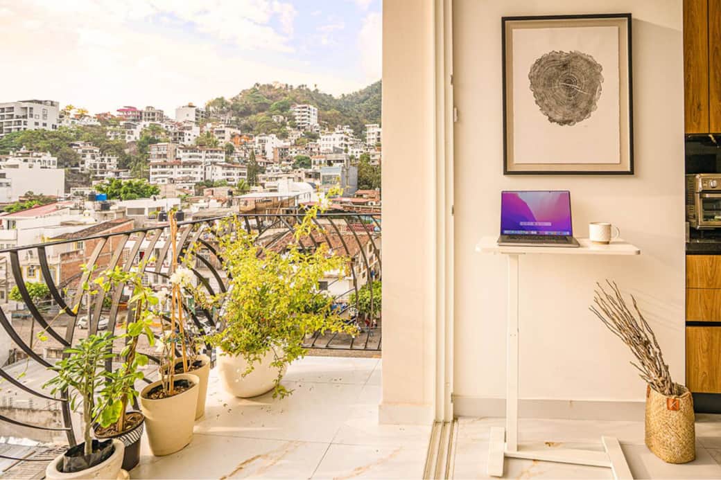 Catch green hillside views from the balcony while your height-adjustable desk keeps your workflow mobile and breezy. Catch green hillside views from the balcony while your height-adjustable desk keeps your workflow mobile and breezy.