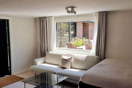 Living room with Falsterbo cushions and garden view