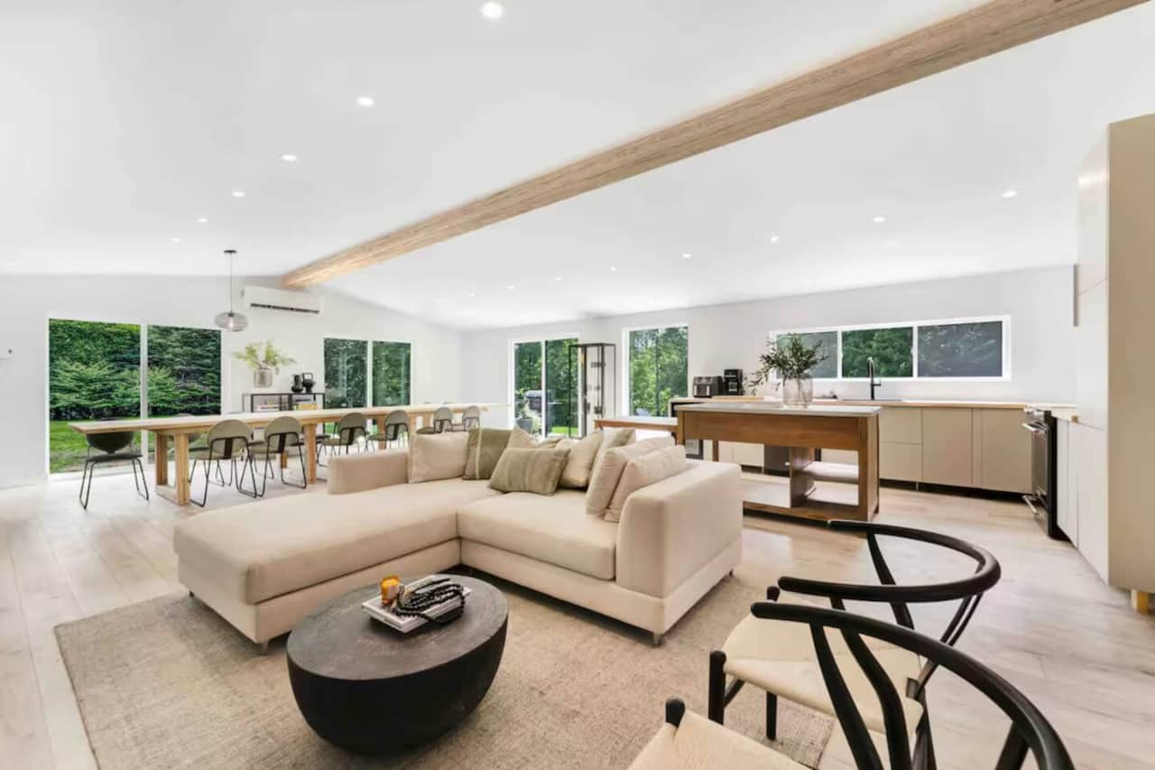 Bright and spacious open-concept living area with large windows and comfortable modern seating